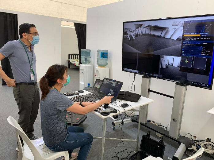 Fig 1: Medical staff learning to navigate robots remotely using DOSS’s remote-control platform at Changi Exhibition Centre (CEC) community isolation facility.